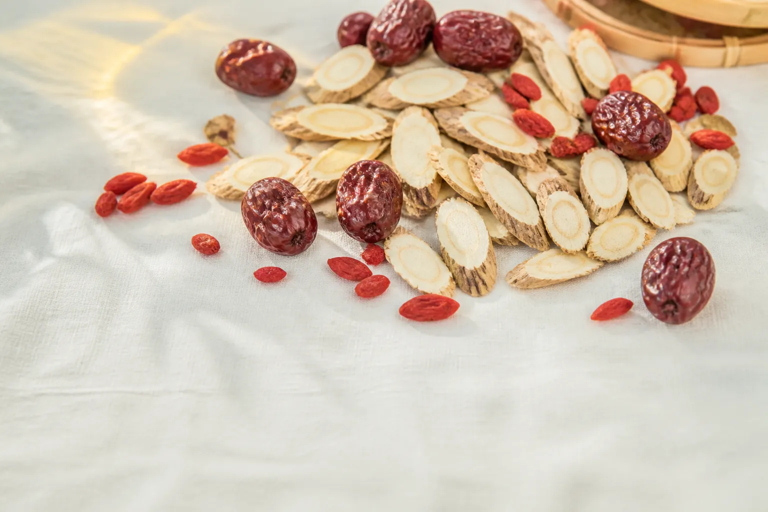 Dried Huang Qi astragalus root slices with red dates and wolfberries for tea at PULSE TCM