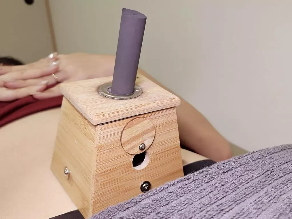 Wooden moxibustion box during a TCM treatment