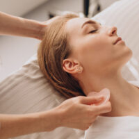 A woman receiving gua sha therapy